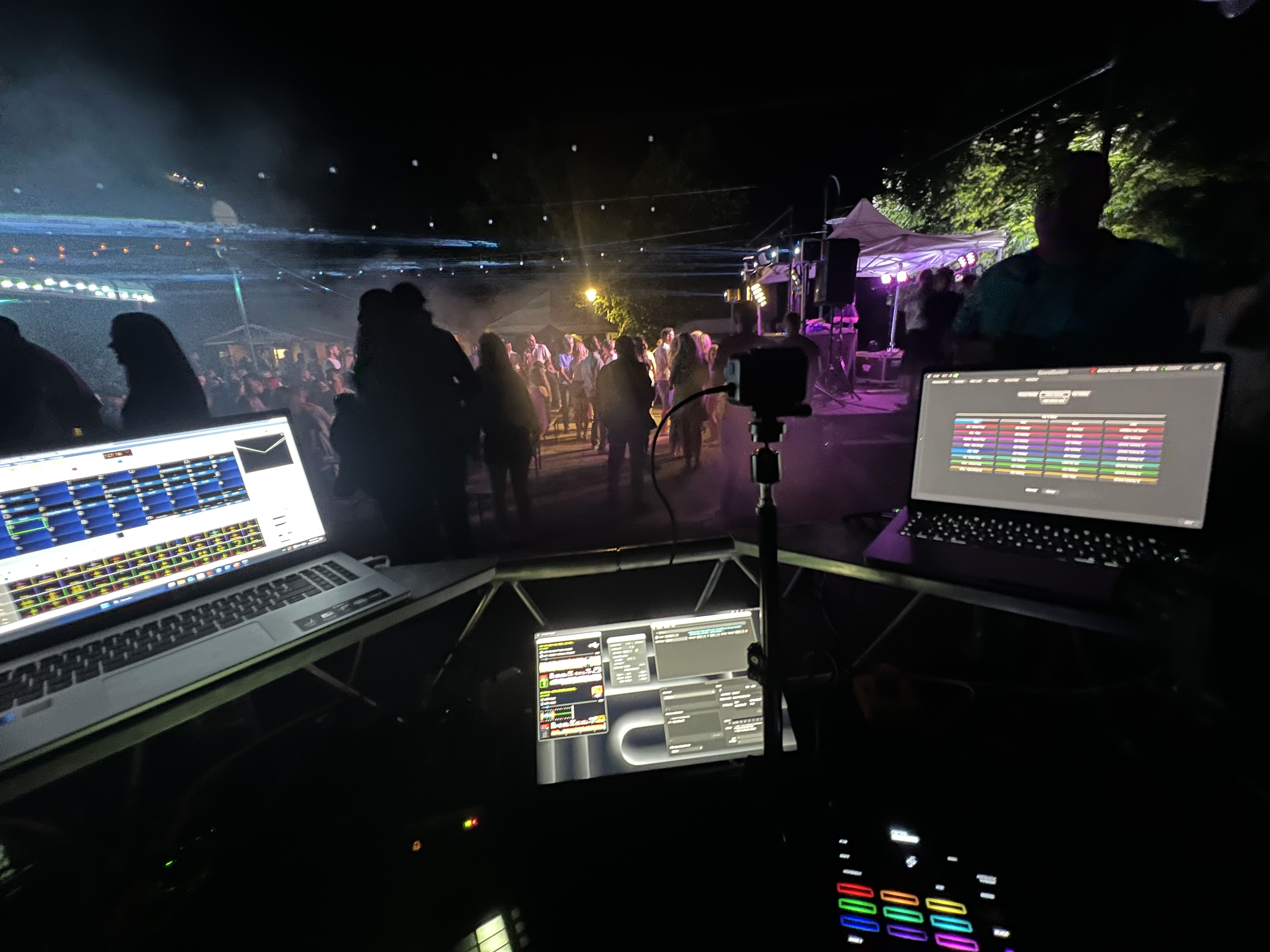 FOH lighting control station and console overlooking the crowd